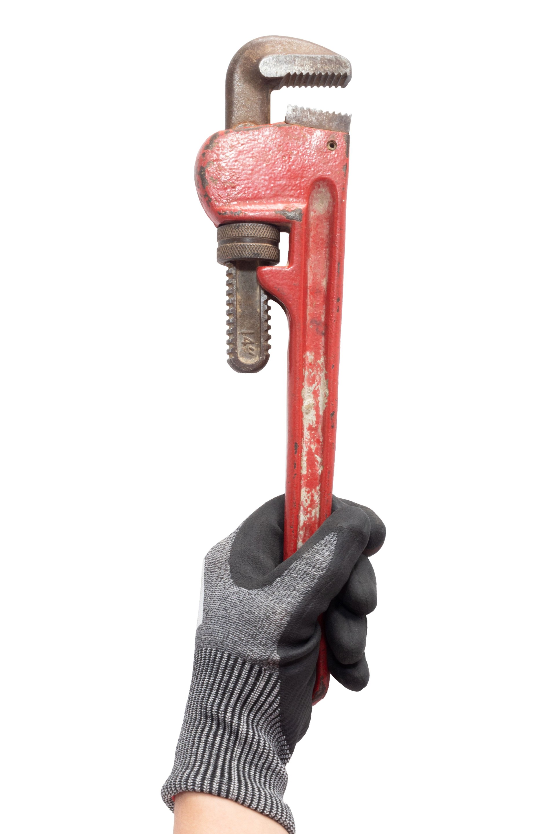 Hand isolated on a white background holds an old pipe wrench. Plumbing tool.